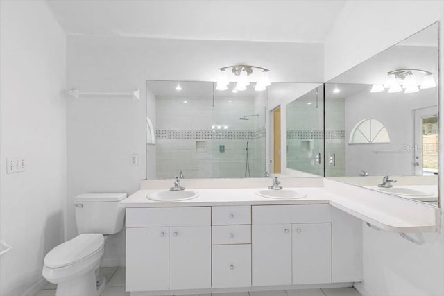 bathroom with a sink, toilet, and a shower stall