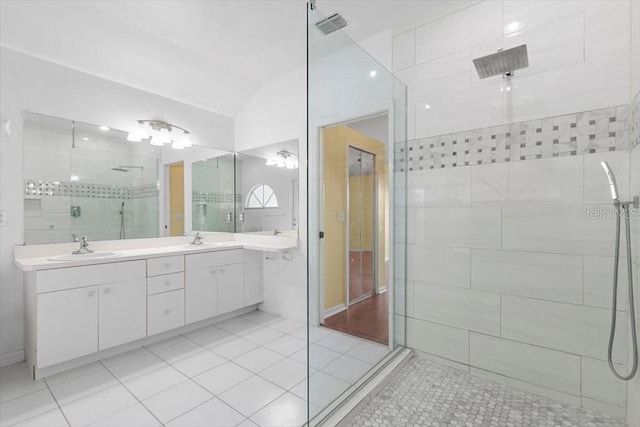 full bathroom featuring a sink, visible vents, tiled shower, and tile patterned flooring