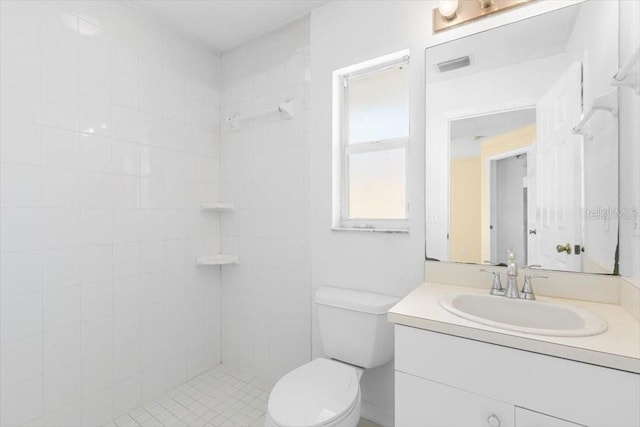 full bath featuring visible vents, toilet, vanity, and a tile shower