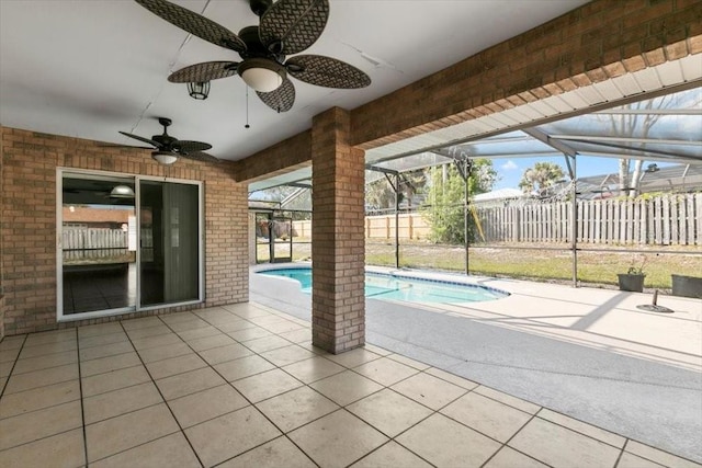 view of swimming pool featuring a fenced in pool, fence, glass enclosure, a patio area, and a ceiling fan