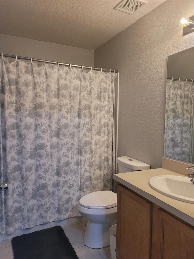 full bath featuring visible vents, toilet, a textured ceiling, vanity, and a textured wall