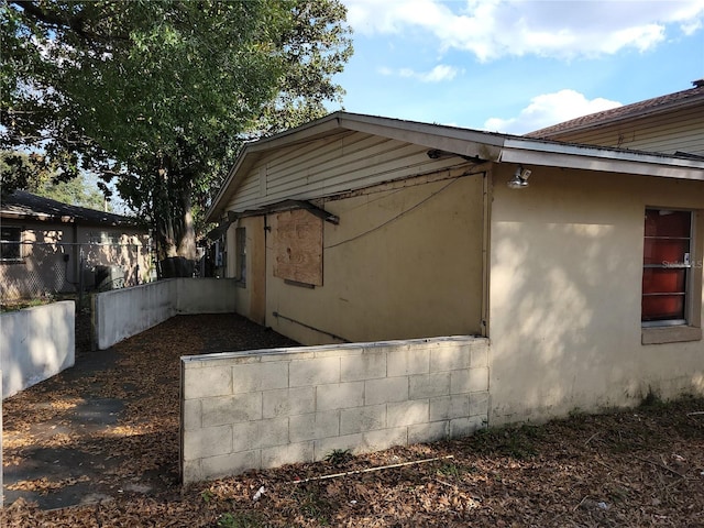 view of property exterior featuring fence