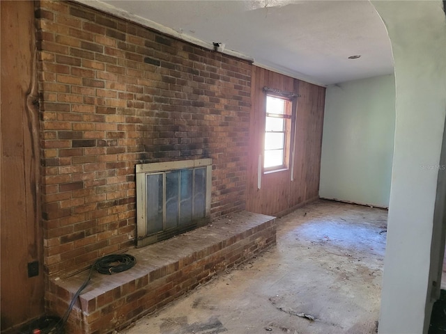 unfurnished living room with a brick fireplace