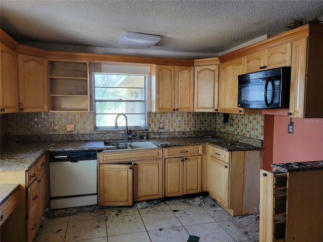 kitchen featuring a sink, decorative backsplash, dishwasher, and black microwave