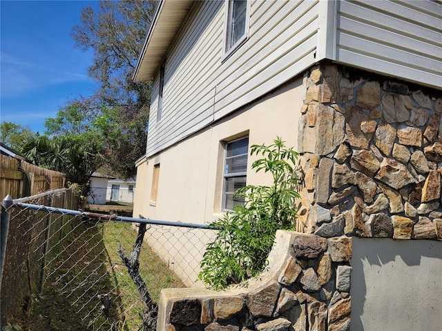 view of property exterior with fence