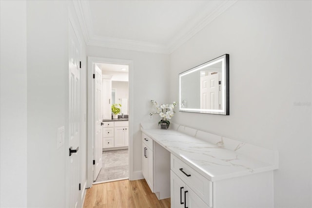 hall featuring light wood-style flooring and crown molding