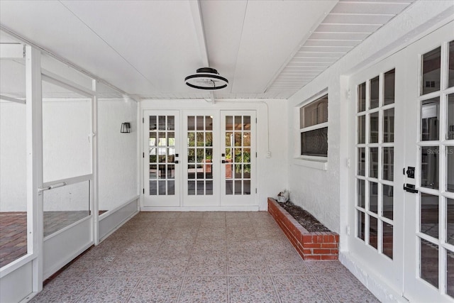 unfurnished sunroom with french doors