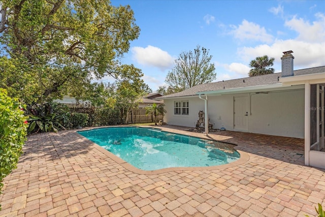 view of swimming pool featuring a fenced in pool, a patio, and fence