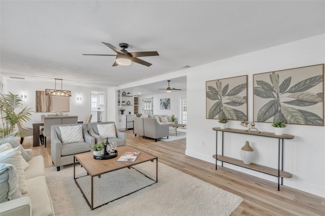 116 E Cottesmore Cir, Longwood, FL 32779 - living area with baseboards, ceiling fan, visible vents, and light wood finished floors