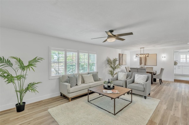 116 E Cottesmore Cir, Longwood, FL 32779 - living room featuring baseboards, light wood-type flooring, and ceiling fan with notable chandelier