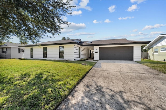 ranch-style house featuring a front yard, a garage, and driveway