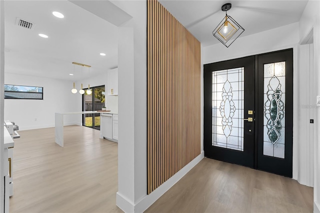 foyer featuring recessed lighting, visible vents, light wood-type flooring, and french doors