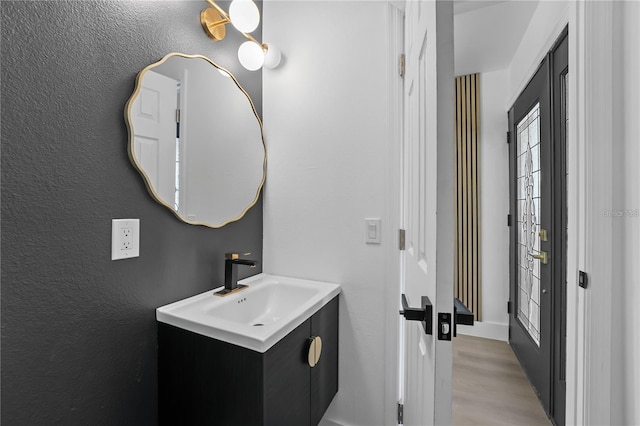607 Dunblane Dr, Winter Park, FL 32792 - bathroom featuring wood finished floors, vanity, and a textured wall