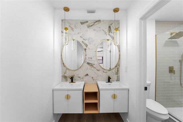 607 Dunblane Dr, Winter Park, FL 32792 - bathroom featuring a sink, wood finished floors, toilet, and a stall shower