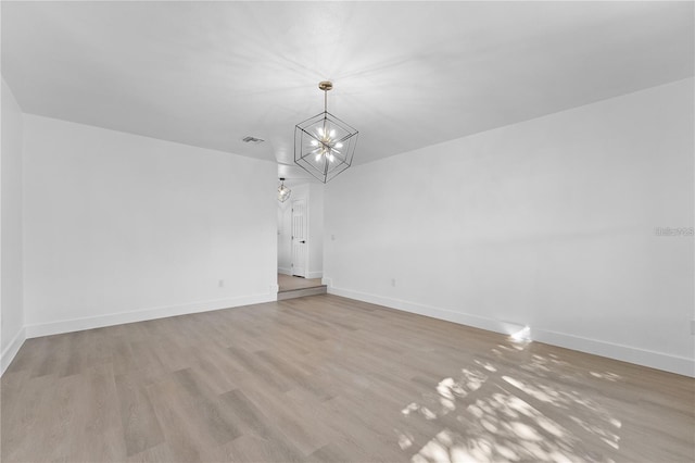 607 Dunblane Dr, Winter Park, FL 32792 - spare room featuring baseboards, wood finished floors, visible vents, and a chandelier