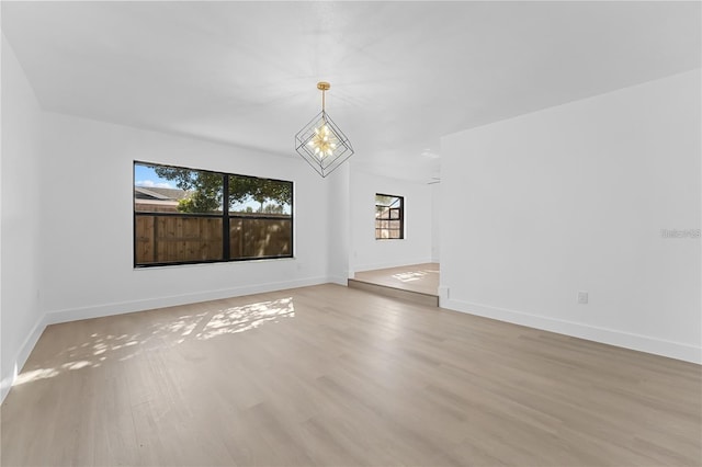 607 Dunblane Dr, Winter Park, FL 32792 - spare room featuring light wood-style floors, baseboards, and a chandelier