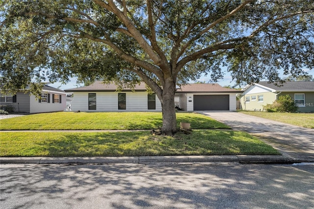 607 Dunblane Dr, Winter Park, FL 32792 - ranch-style home with a front yard, an attached garage, and driveway