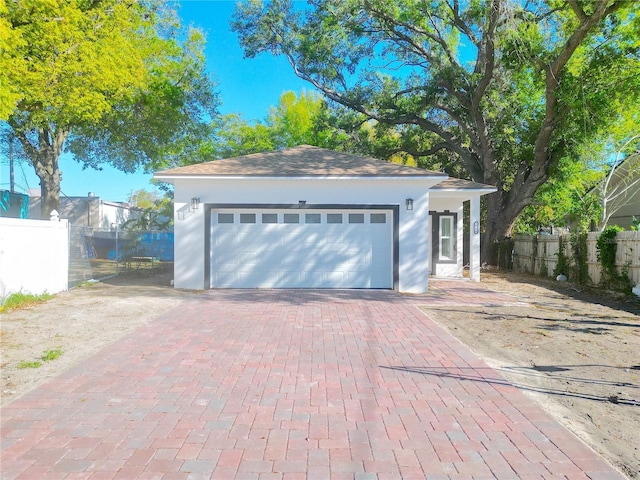 garage with driveway and fence