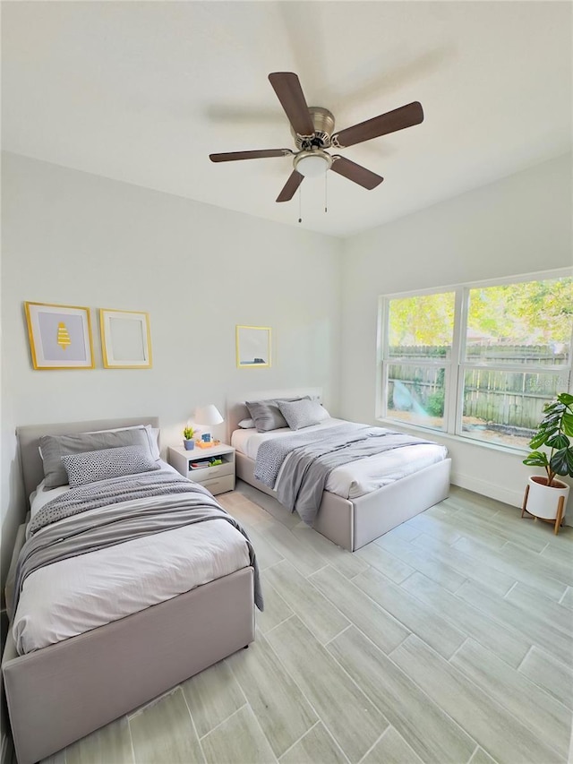 bedroom featuring wood tiled floor and a ceiling fan