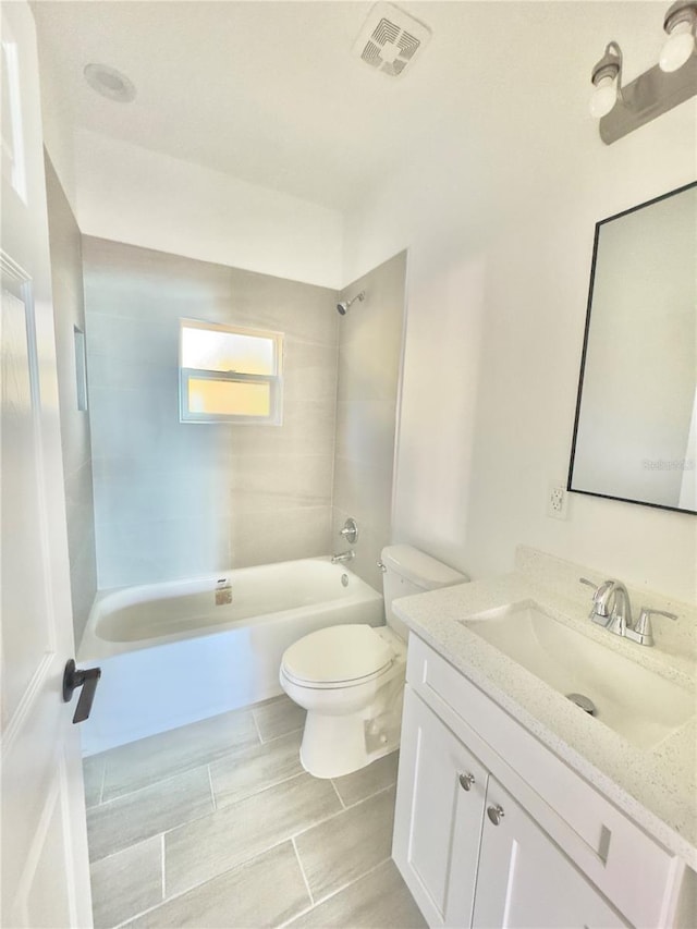 full bathroom featuring shower / bathing tub combination, toilet, visible vents, and vanity