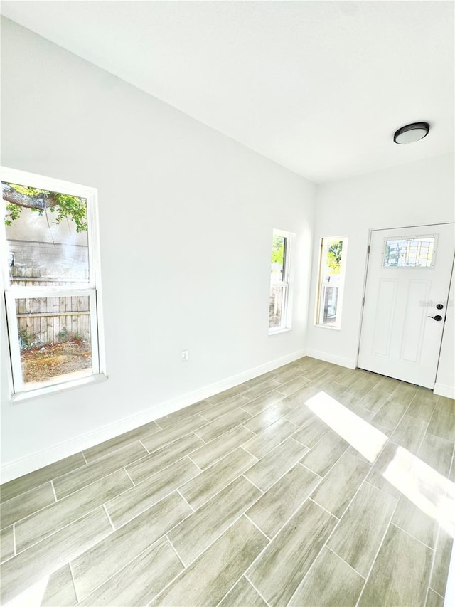 entrance foyer featuring wood finish floors and baseboards