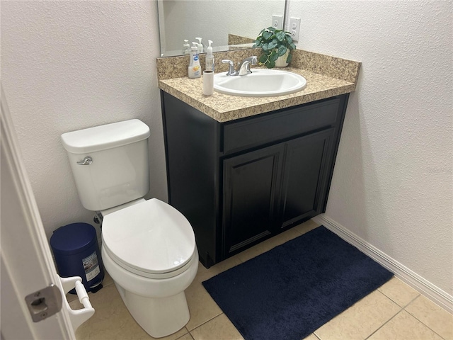 half bath featuring tile patterned floors, toilet, and vanity