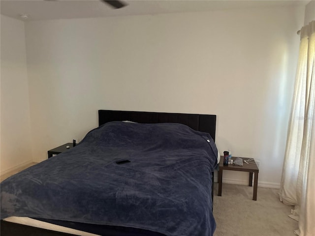 bedroom featuring baseboards and carpet floors