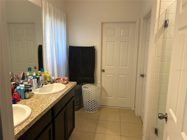 bathroom with tile patterned flooring, double vanity, walk in shower, and a sink