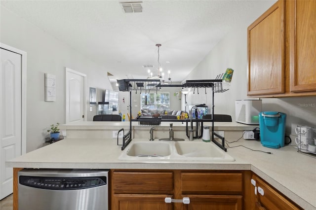 kitchen featuring visible vents, a sink, light countertops, stainless steel dishwasher, and open floor plan