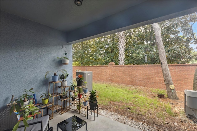 view of patio featuring central air condition unit and fence