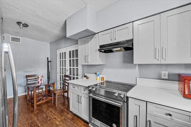 kitchen with under cabinet range hood, stainless steel range with electric stovetop, and light countertops