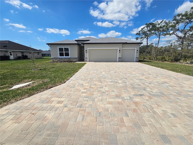 view of front of house featuring stucco siding, a front lawn, decorative driveway, stone siding, and a garage