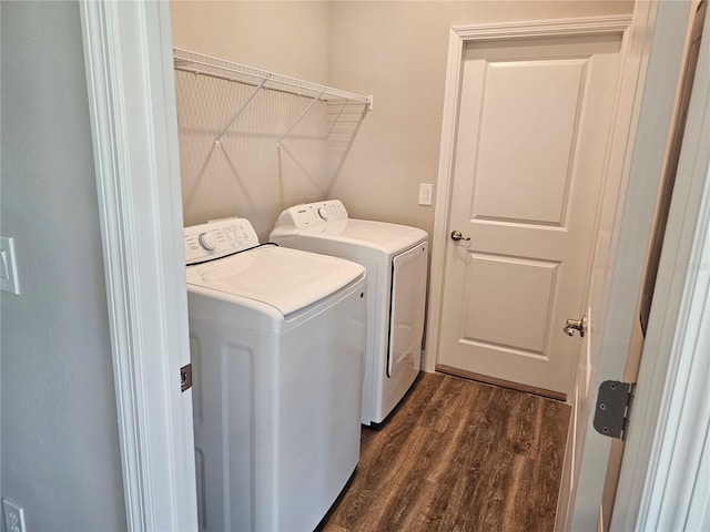 clothes washing area with laundry area, dark wood-style floors, and washing machine and dryer