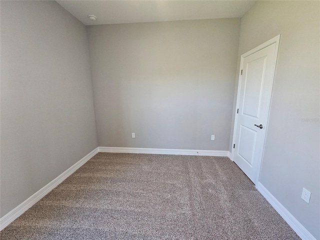 unfurnished room with baseboards and carpet flooring