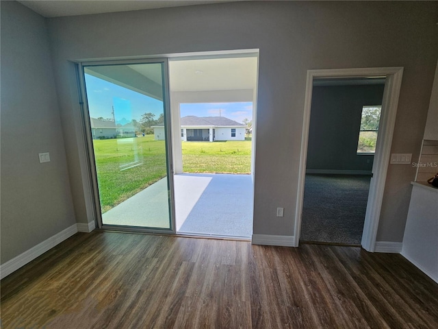 interior space with baseboards and dark wood-style flooring