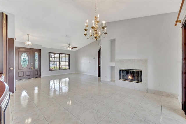 unfurnished living room featuring ceiling fan with notable chandelier, vaulted ceiling, a fireplace, and baseboards