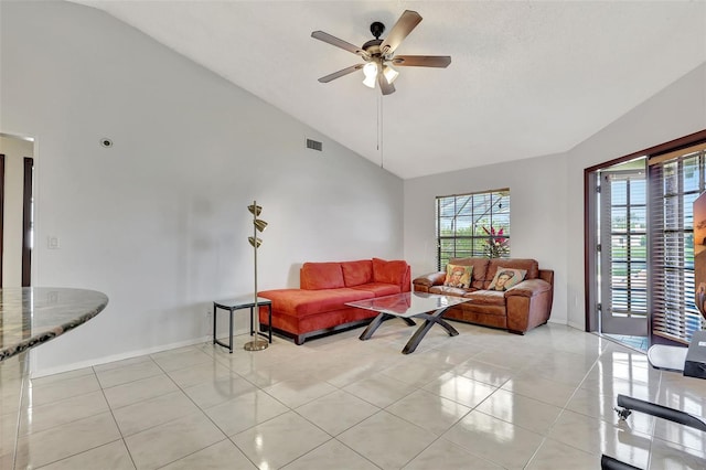 living area with light tile patterned floors, visible vents, high vaulted ceiling, and ceiling fan