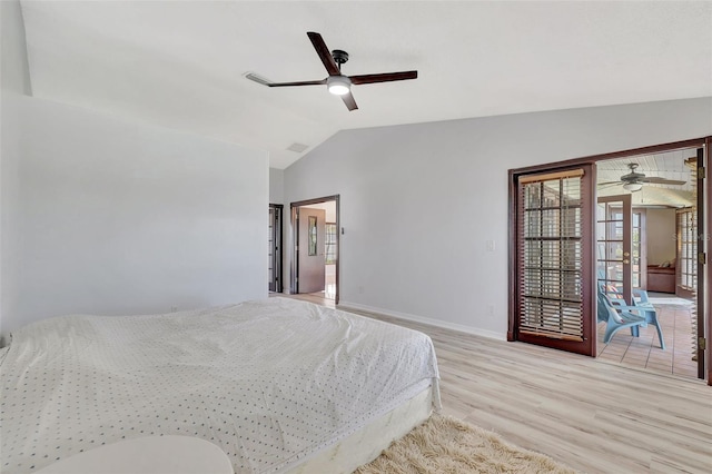 bedroom featuring visible vents, lofted ceiling, a ceiling fan, wood finished floors, and baseboards