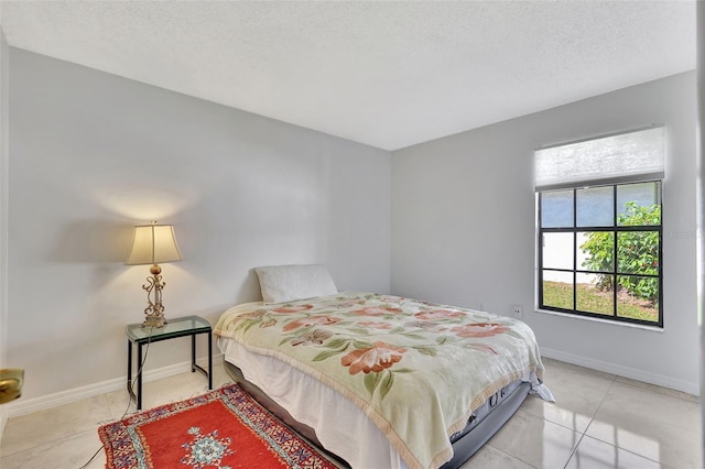 bedroom featuring a textured ceiling and baseboards