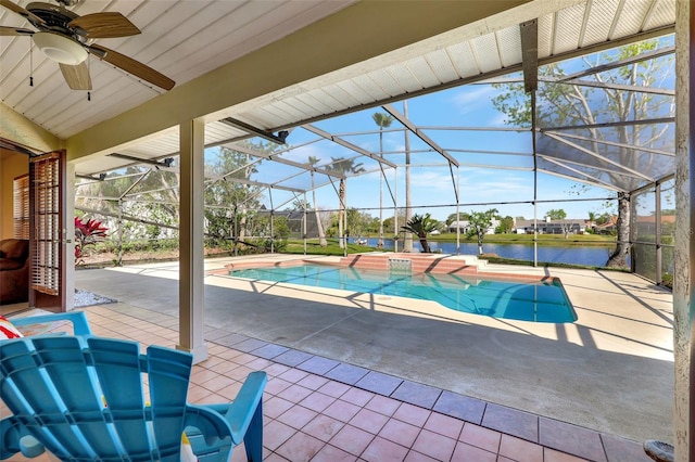 pool featuring a lanai, ceiling fan, a patio, and a water view