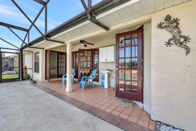 doorway to property with a patio area, stucco siding, and ceiling fan