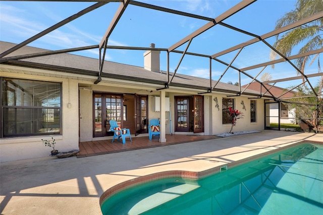 pool with french doors, a lanai, and a patio area