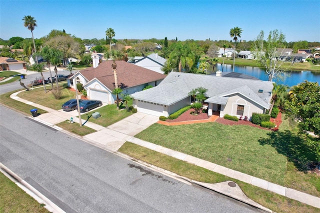 drone / aerial view featuring a residential view and a water view