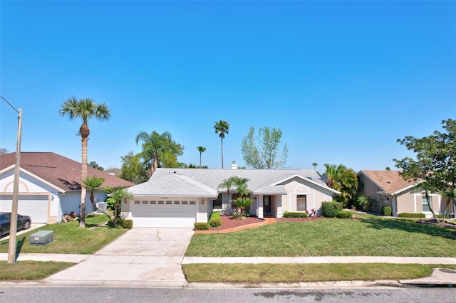 view of front of home with a front yard, an attached garage, driveway, and stucco siding