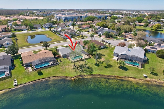 drone / aerial view with a residential view and a water view