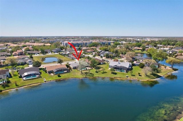 drone / aerial view with a residential view and a water view