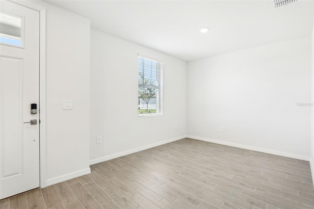 empty room with recessed lighting, baseboards, visible vents, and light wood-type flooring