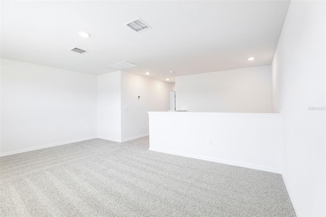 unfurnished room with carpet, visible vents, and recessed lighting