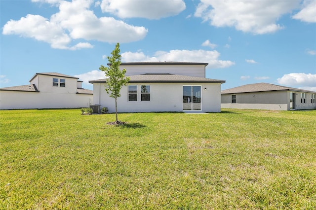 back of house featuring a lawn and central air condition unit