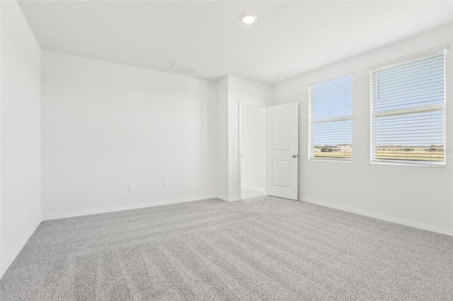 empty room featuring baseboards, carpet flooring, and recessed lighting